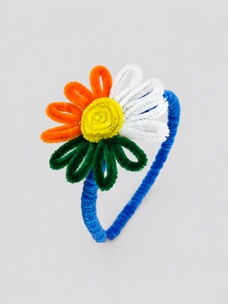 Handmade colorful flower headband with yellow center and orange white petals on blue band